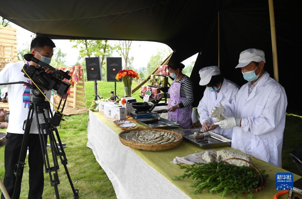 安寧省合肥市肥西県柿樹崗郷で、ライブ配信で地元特産グルメのヨモギ餅を紹介する村民（5月15日撮影・劉軍喜）。