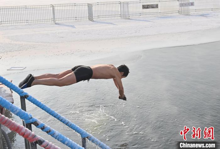 極寒の中、水中に飛び込むスイマー（撮影・張瑶）。